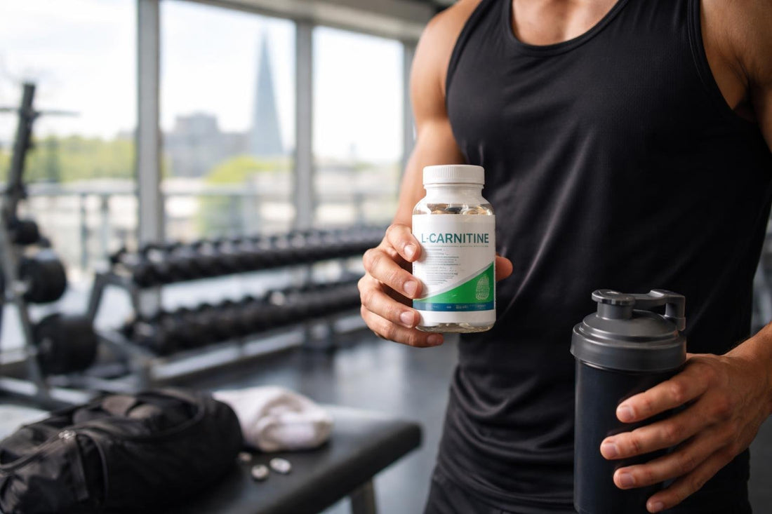 Gym-goer holding carnitine supplement bottle in London gym