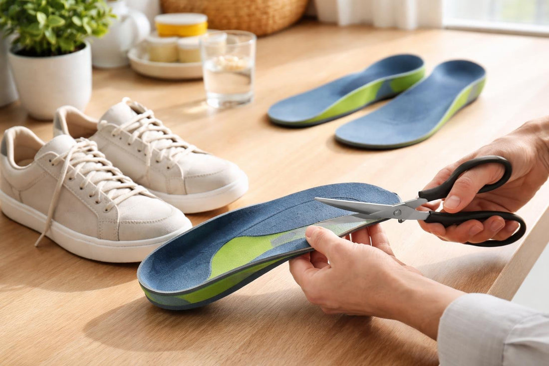 Hands trimming arch support insole to fit shoe