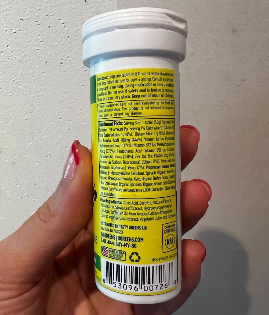 8Greens bottle resting on a counter, bright lemon-lime label visible.