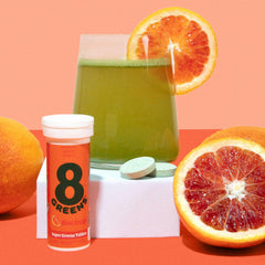 8Greens morning routine with tablets and water for daily greens.