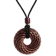 Abrakadoubra Tensor Rings copper pendant with double vortex for energy balance during meditation.