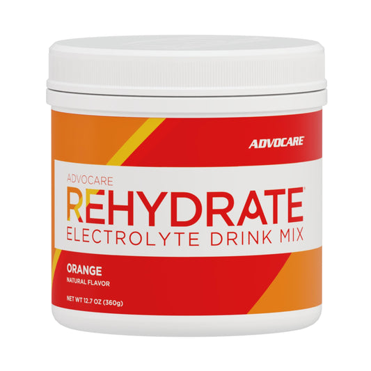 AdvoCare Rehydrate bottle pours bright orange drink for rapid hydration after workouts.