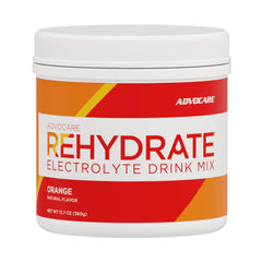AdvoCare Rehydrate bottle pours bright orange drink for rapid hydration after workouts.