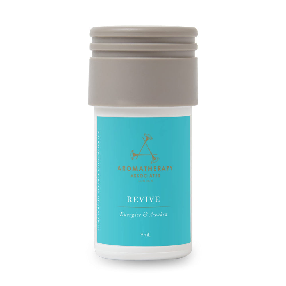 Aera Revive bottle close-up showing juniper berry, rosemary, grapefruit for a refreshing ambiance.