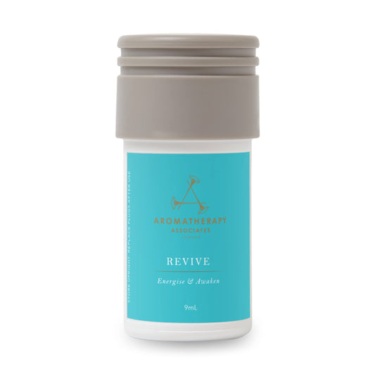 Aera Revive bottle close-up showing juniper berry, rosemary, grapefruit for a refreshing ambiance.