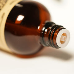 AKARZ Tulip Oil beside rose, showing a delicate perfume blend option.