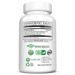 Allied Life vegan protein greens capsules pictured with fresh vegetables.