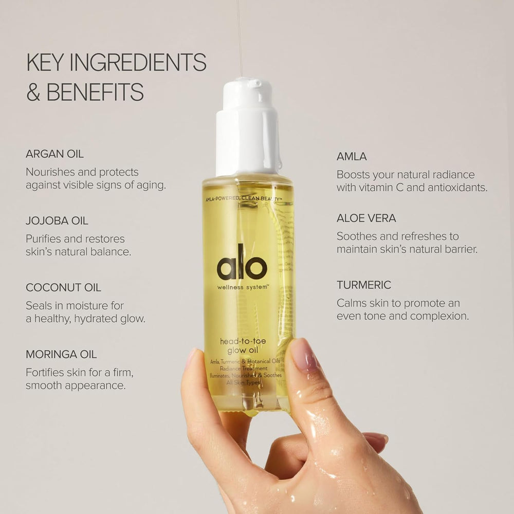 Alo Head-to-Toe Glow Oil bottle with visible golden droplets for luminous skin.