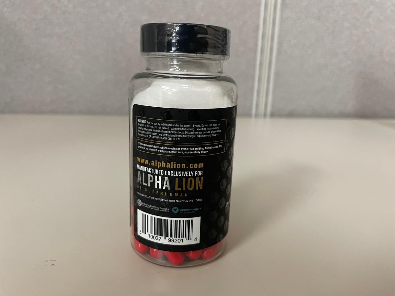 ALPHA LION Gains Candy product shot with glass and greens.
