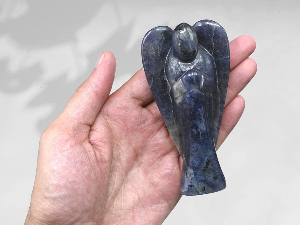 Amazing Gemstone Iolite Angel near a shelf inspires calm, focus, and guardianship.