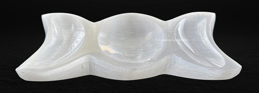 Amazing Gemstone selenite charging plate on an altar, creating a tranquil space.