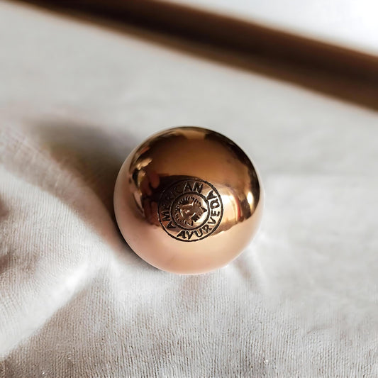 American Ayurveda copper ball grounding energy to balance body and mind.