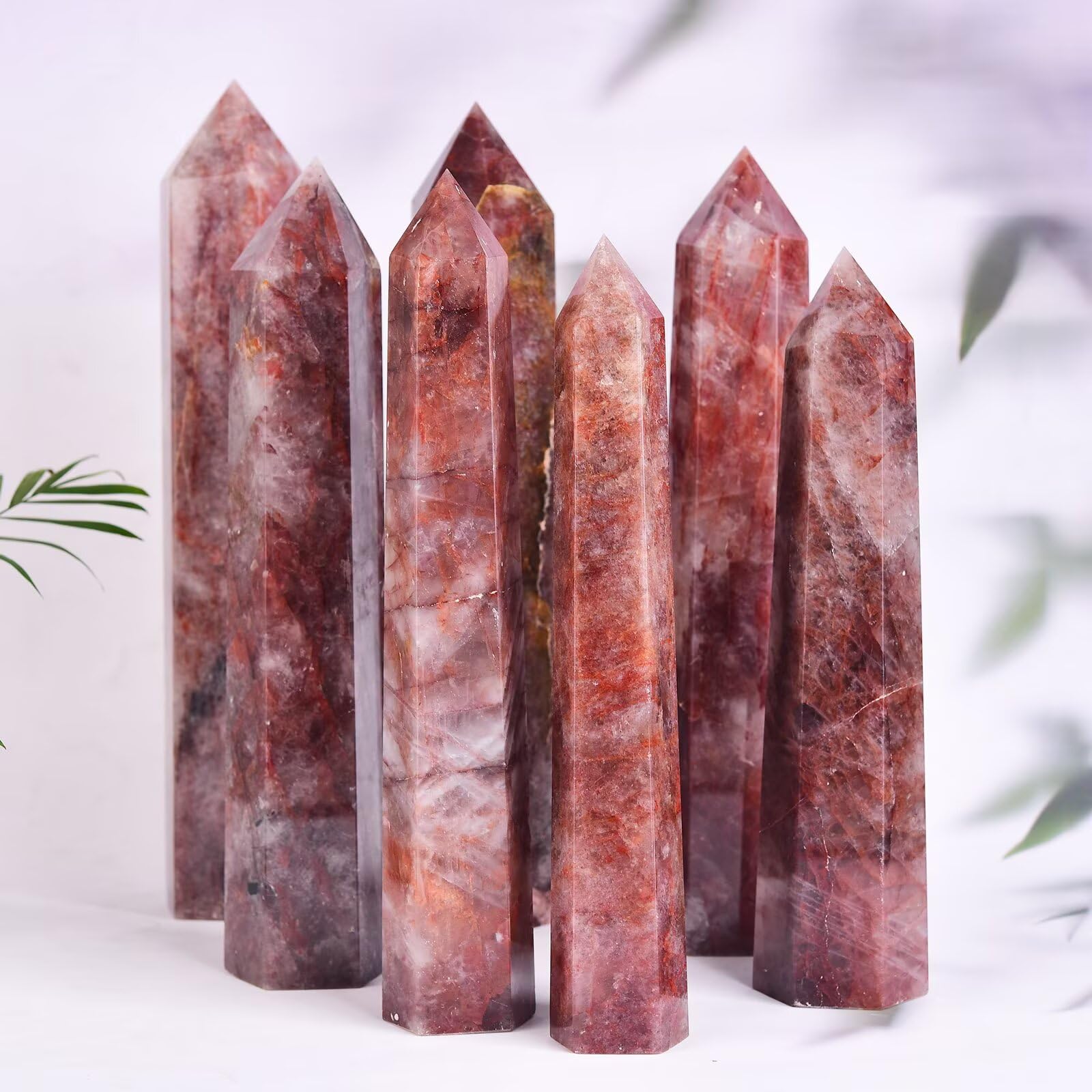 AMOYSTONE Hematoid Quartz wand lit with daylight showing depth and texture.