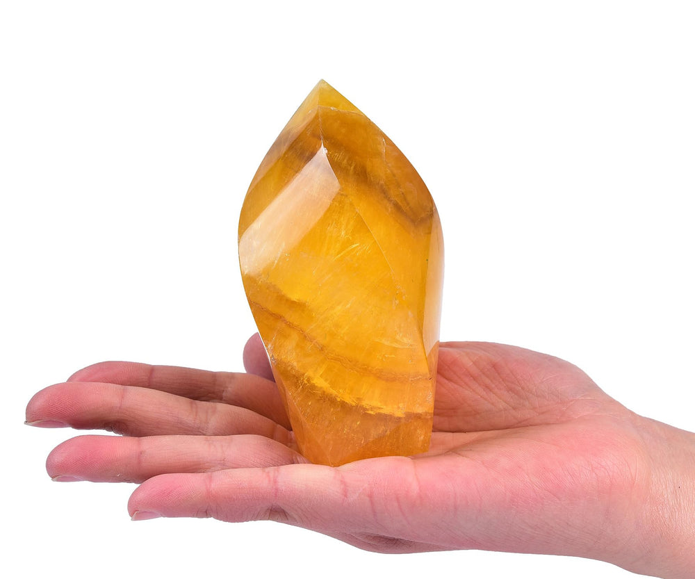 AMOYSTONE orange fluorite tower placed on a desk to enhance calm and creativity.