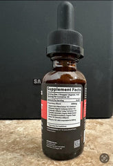 Apetropics Smart Drops peach-watermelon flavor in a glass with fruit accents for tasting appeal.