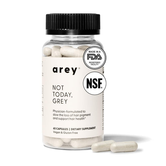 Close-up of Arey Not Today capsules for thicker, healthier hair.