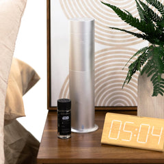 Aroma360 diffuser in a serene hotel room setting for calming aroma diffusion.