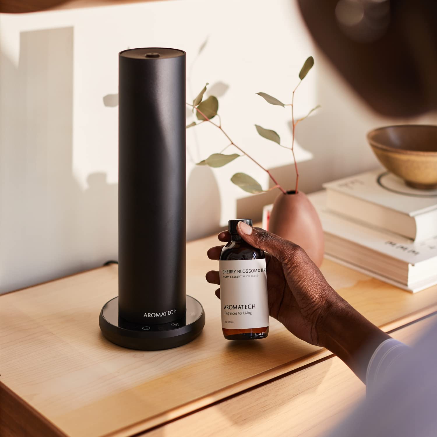 AromaTech Cherry Blossom Hinoki diffuser dispensing a clean floral scent