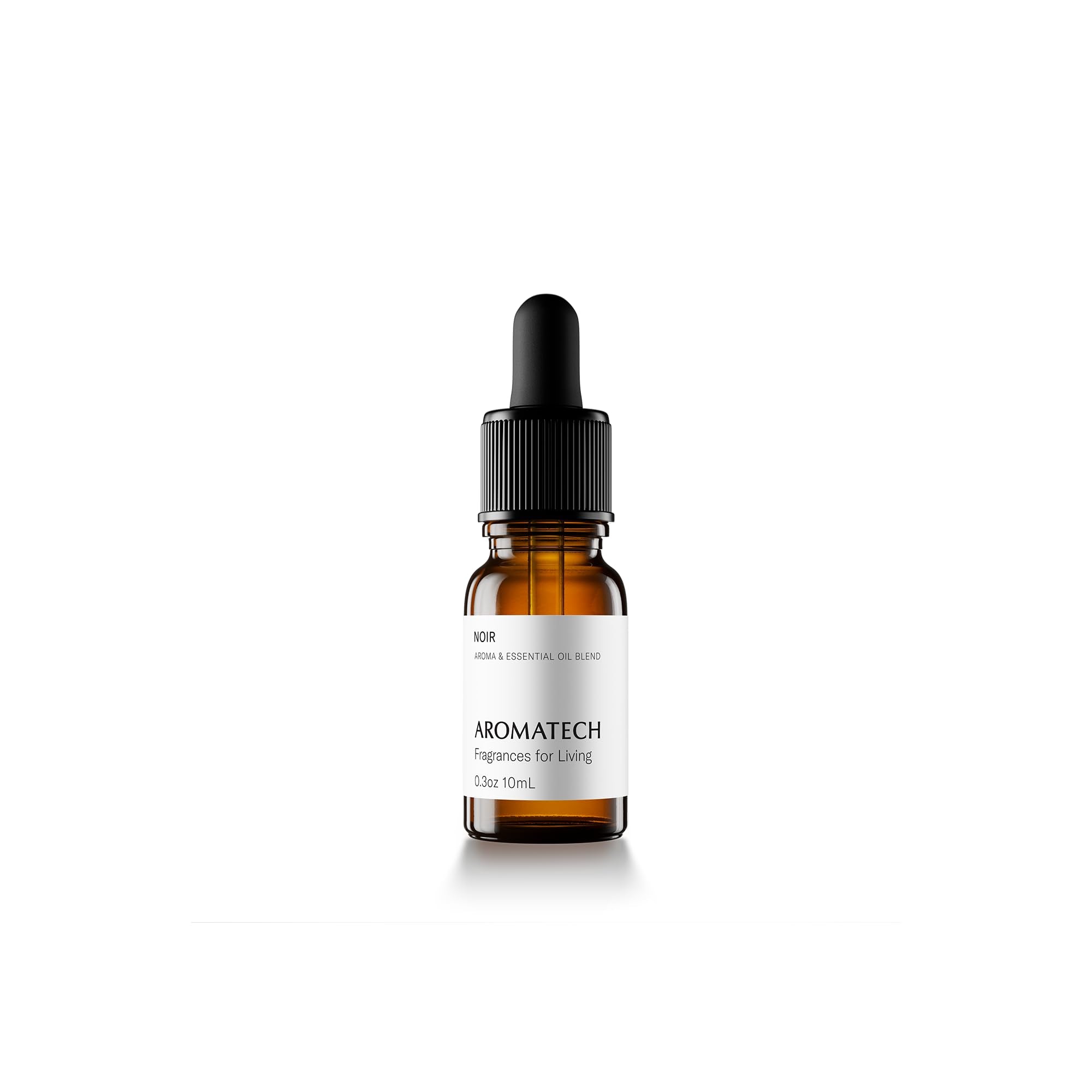 AromaTech Noir bottle close-up highlighting cedarwood and musk in a premium home setting.