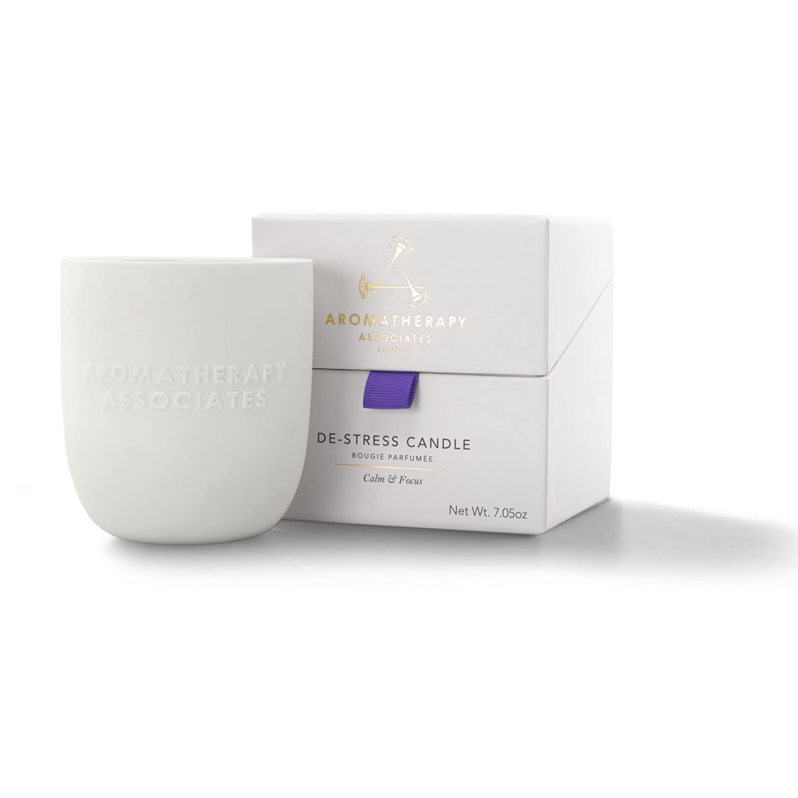Aromatherapy Associates De-Stress candle in a ceramic holder creates a calm space.