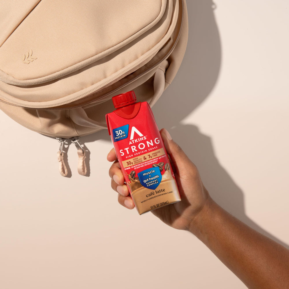 Atkins Strong shake with foamy crema in a mug, flavorful protein support.