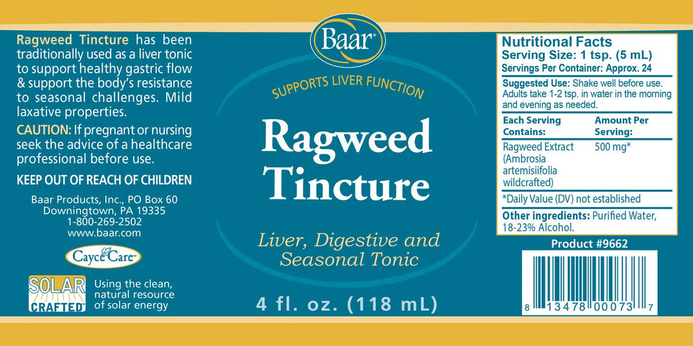 Dropping Baar Ragweed Tincture into a drink for liver support.