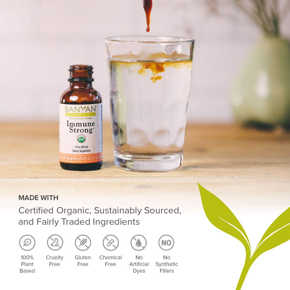 Pour of Banyan Botanicals Immune Strong into a glass, amber liquid