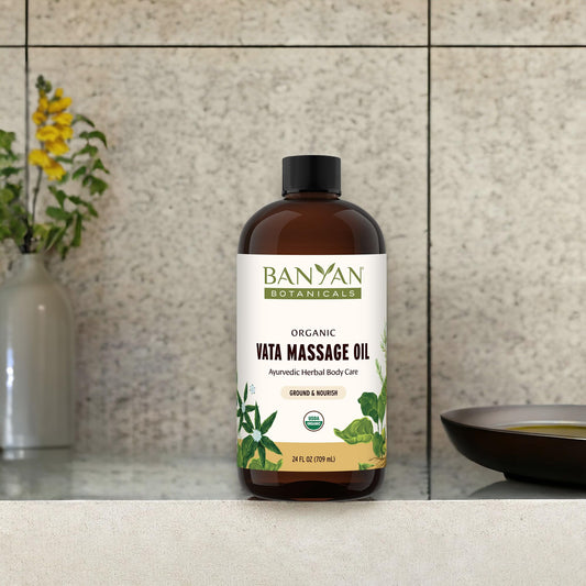 Banyan Botanicals Vata Massage Oil bottle being poured for use