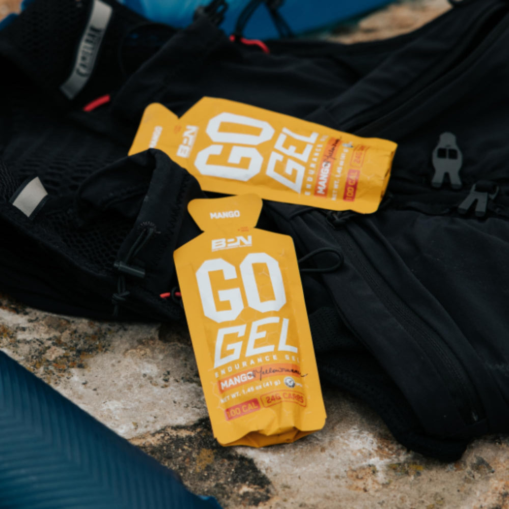 BARE PERFORMANCE NUTRITION BPN Go Gel Endurance athlete during run with gel for energy.
