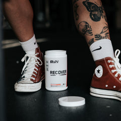 Bare Performance Nutrition BPN Recover fruit punch scoop mixing for refreshing amino acid replenishment.