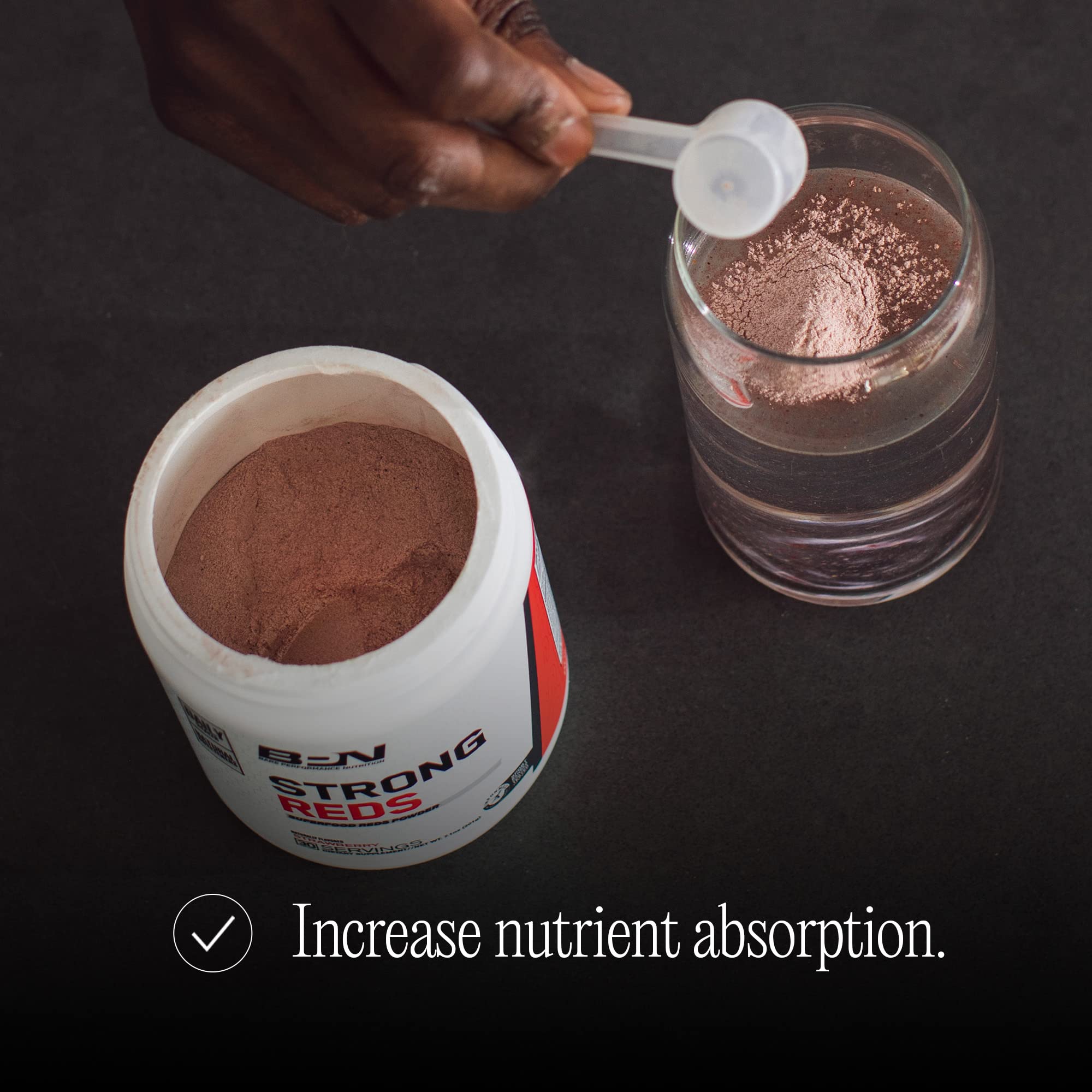 Bare Performance Nutrition Strong Reds powder dispersing in liquid for natural energy.