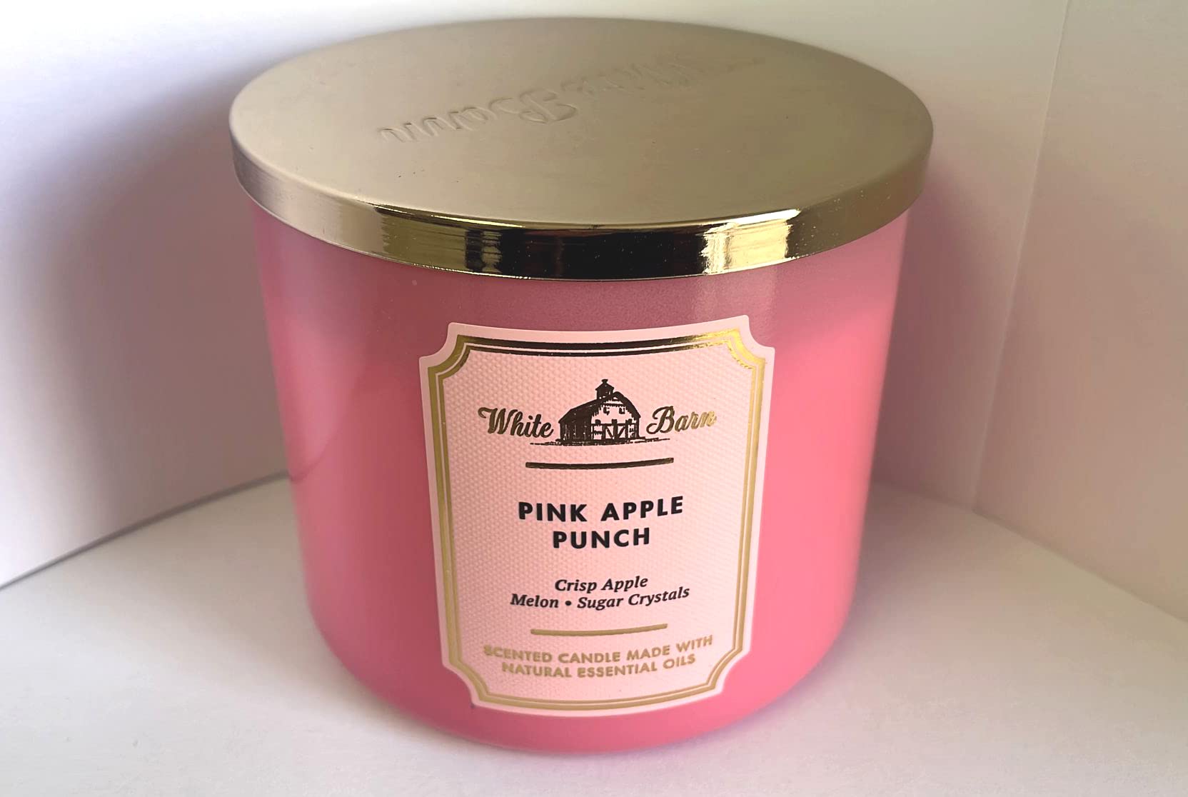Closeup of Pink Apple Punch label on Bath and Body Works White Barn 3-Wick Candle highlighting essential oils