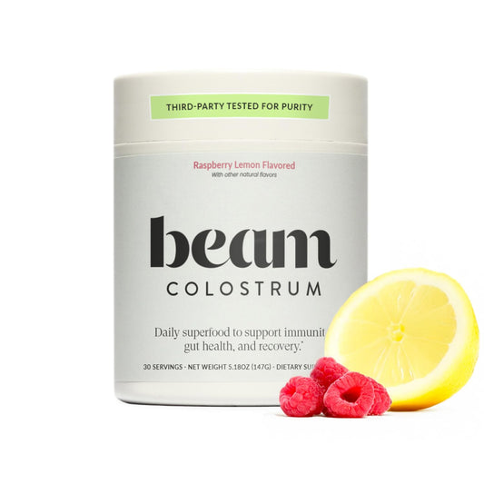 Beam Colostrum Powder bottle shows grass-fed formula for daily gut and immune support.