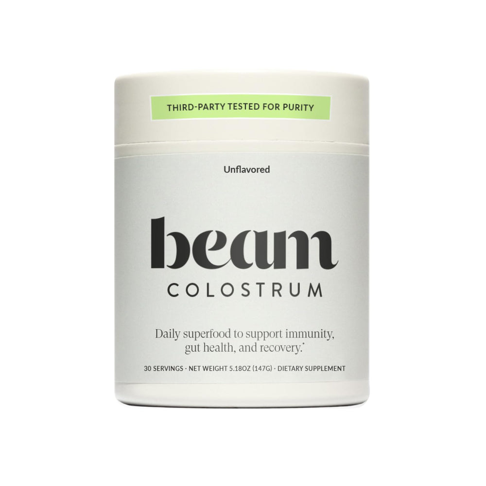 Beam Colostrum Powder with scoop shows a 3g serving for gut health.