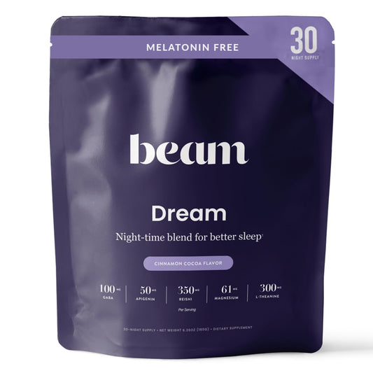 Beam Dream Sleep Powder bottle on a nightstand for calm before bed.