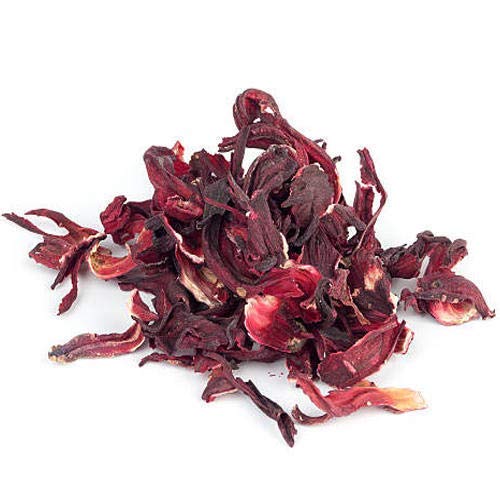 Bixa Botanical Hibiscus Powder being mixed into juice for versatile use.