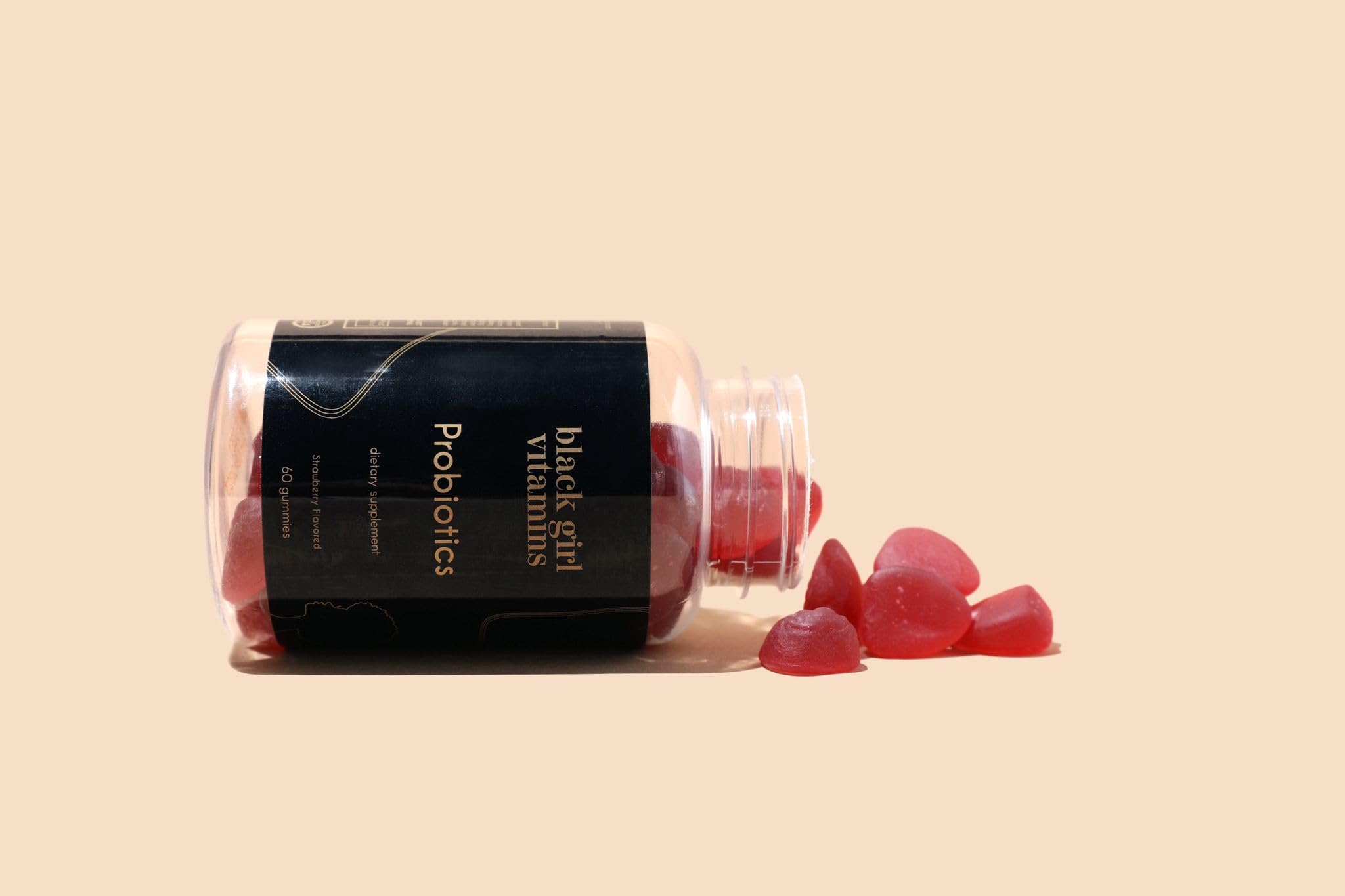Black Girl Vitamins probiotic gummies packaging display emphasizing vegan, gluten-free formula.