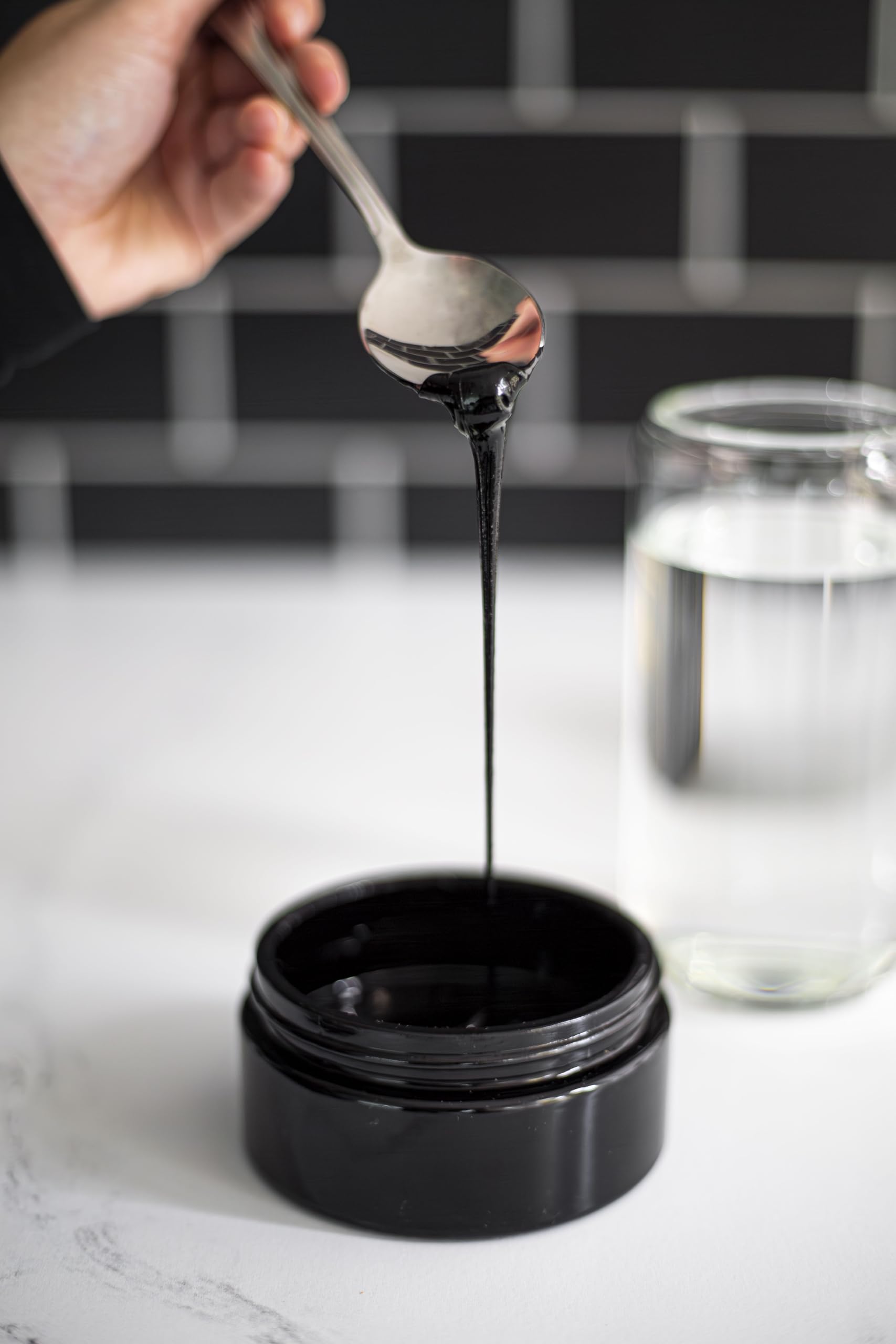 Black Lotus Shilajit Resin dissolving in water for daily energy