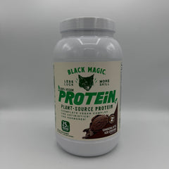 Black Magic vegan protein tub on counter, keto-friendly with low sugar