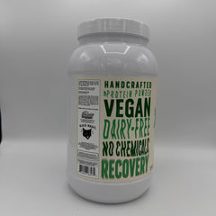 Pouring Black Magic vegan protein into a shaker for a smooth shake