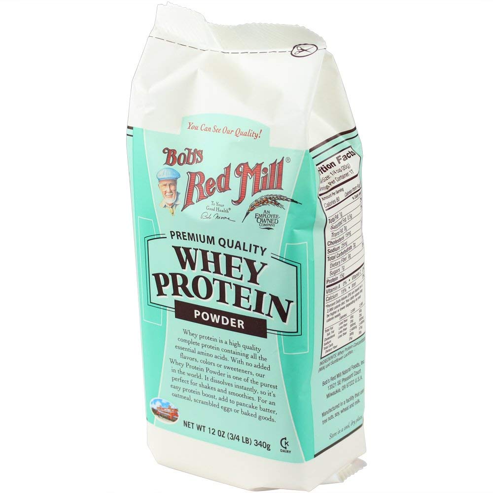 Bob's Red Mill Whey Protein Concentrate scoop pouring into shaker for shakes.