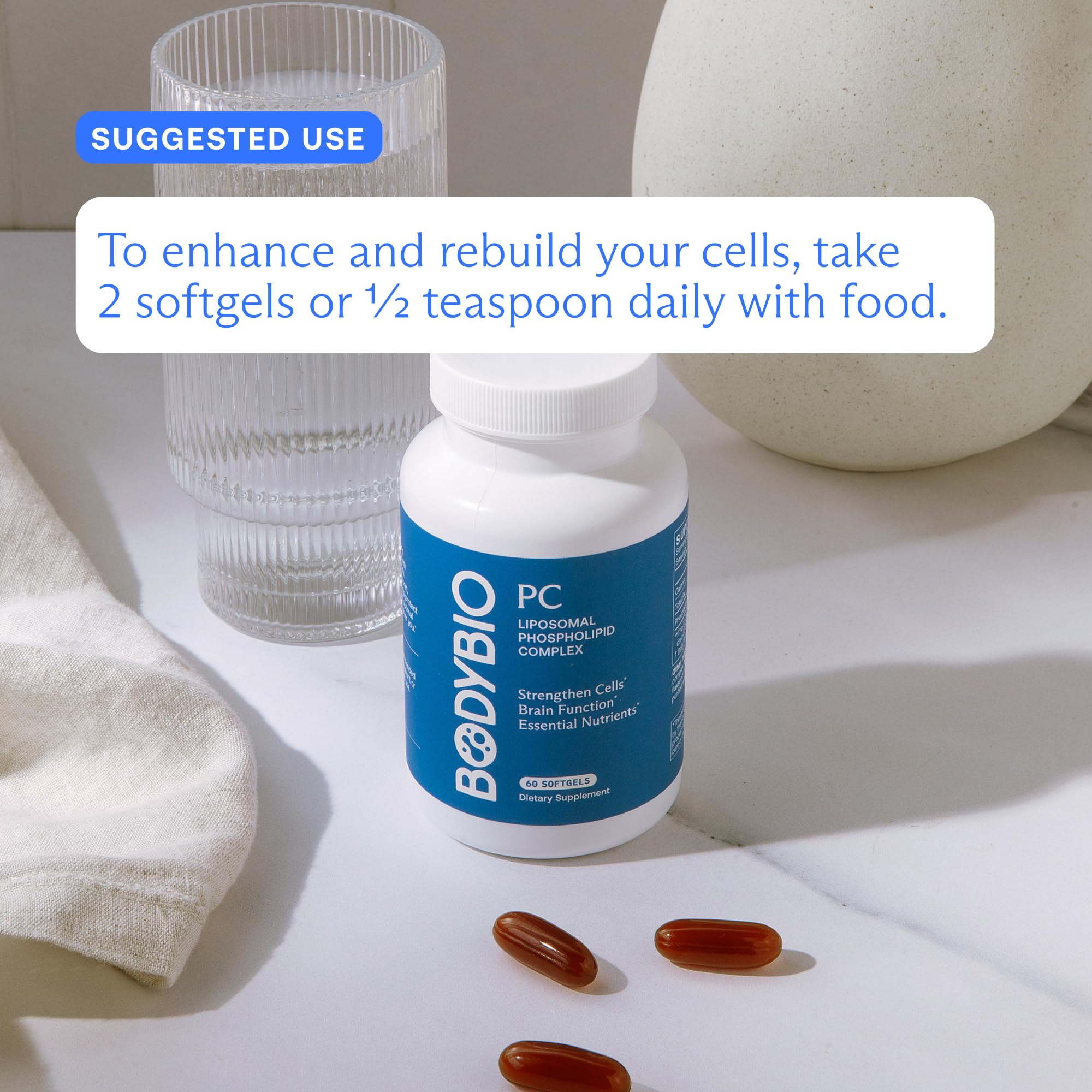 BodyBio PC capsules beside a glass of water illustrating easy daily intake.