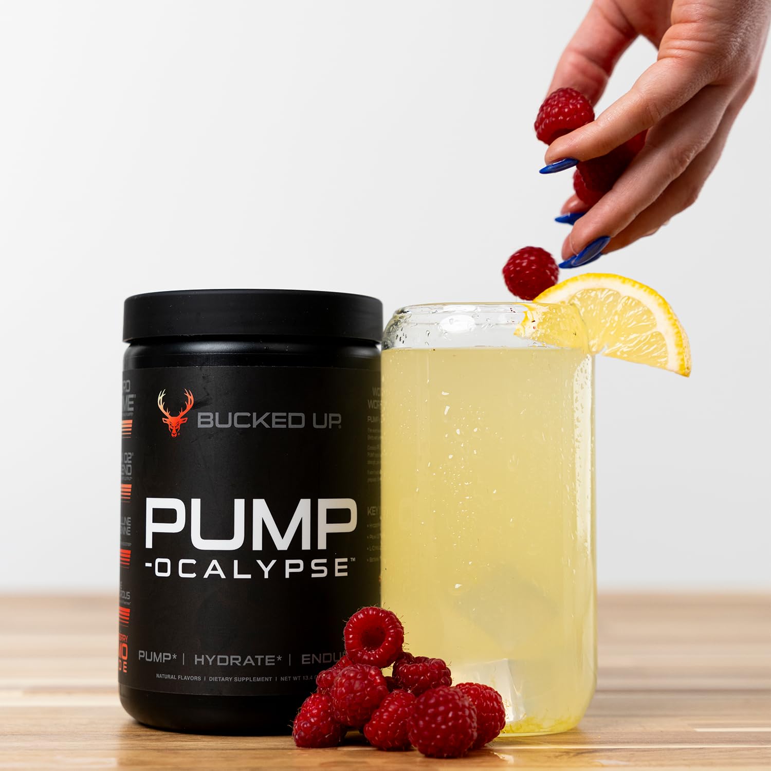 Athlete mixing Bucked Up Pump-ocalypse Raspberry Lemonade before workout