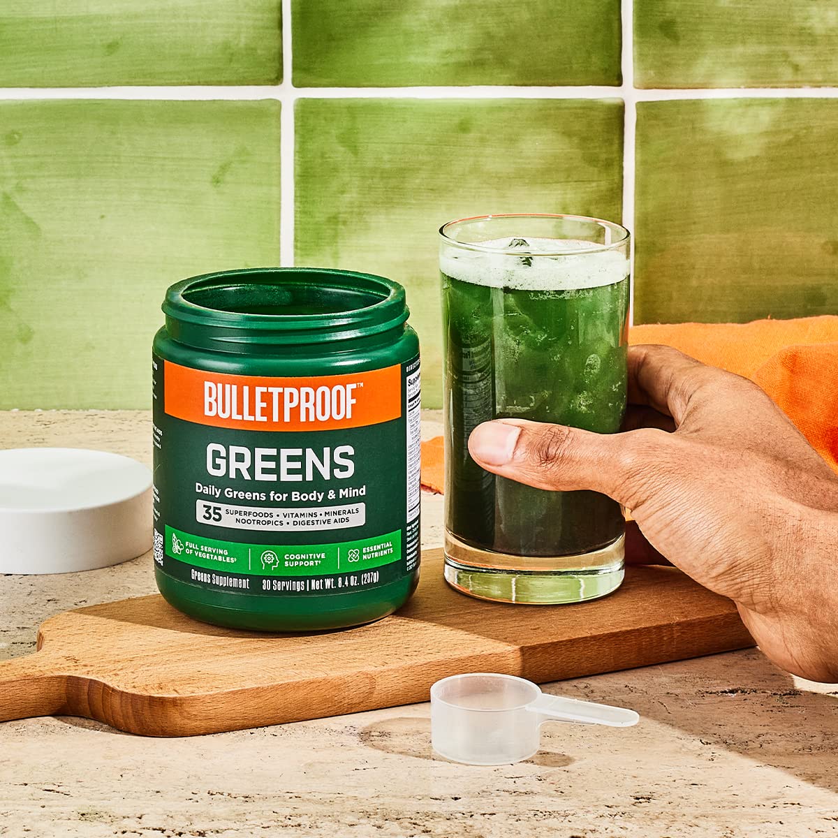Bulletproof Greens scoop beside a glass illustrating a simple daily serving