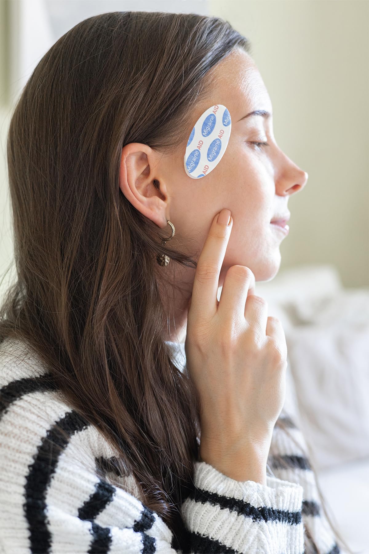 CarpalAid Migraine AID patch demonstrating easy application