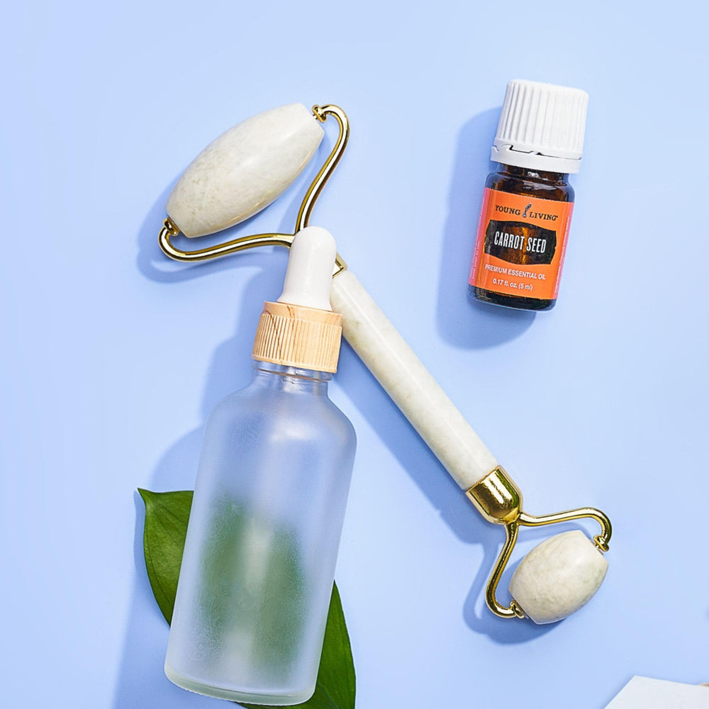 Young Living Carrot Seed Oil 5 ml shown with diffuser for relaxing ambience.