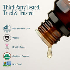 Cliganic Tea Tree essential oil bottle close-up illustrating versatile cleaning and skin care applications