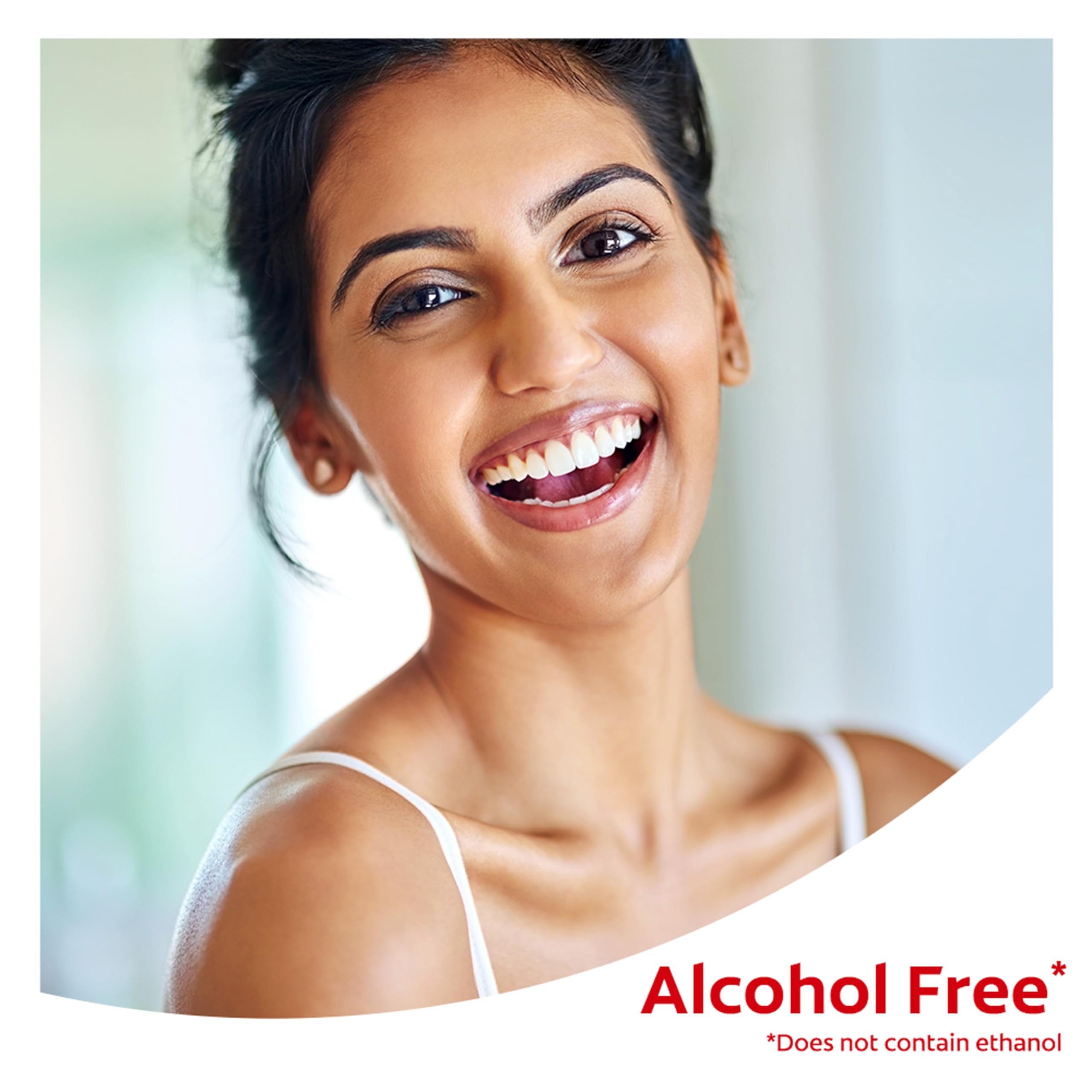 Mouthwash beside toothbrush demonstrates post-brushing routine with Colgate Optic White.