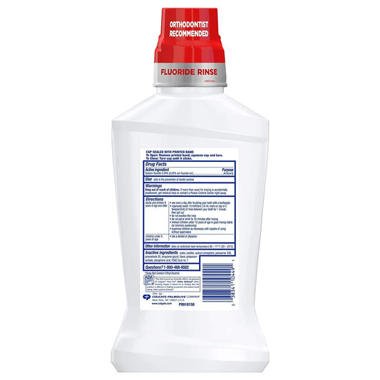 Cap of Colgate Phos-Flur mint rinse for precise daily dosing.
