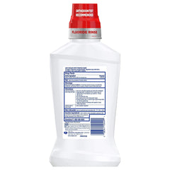 Cap of Colgate Phos-Flur mint rinse for precise daily dosing.
